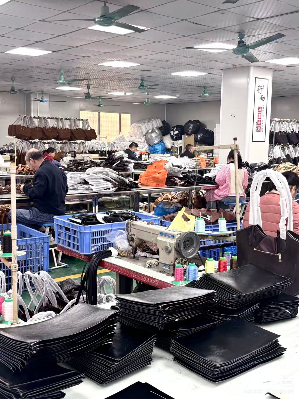 Bag production floor with sewing stations and prepared components